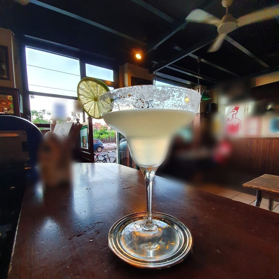 Un cocktail col bordo di sale e una fetta di lime sul bancone