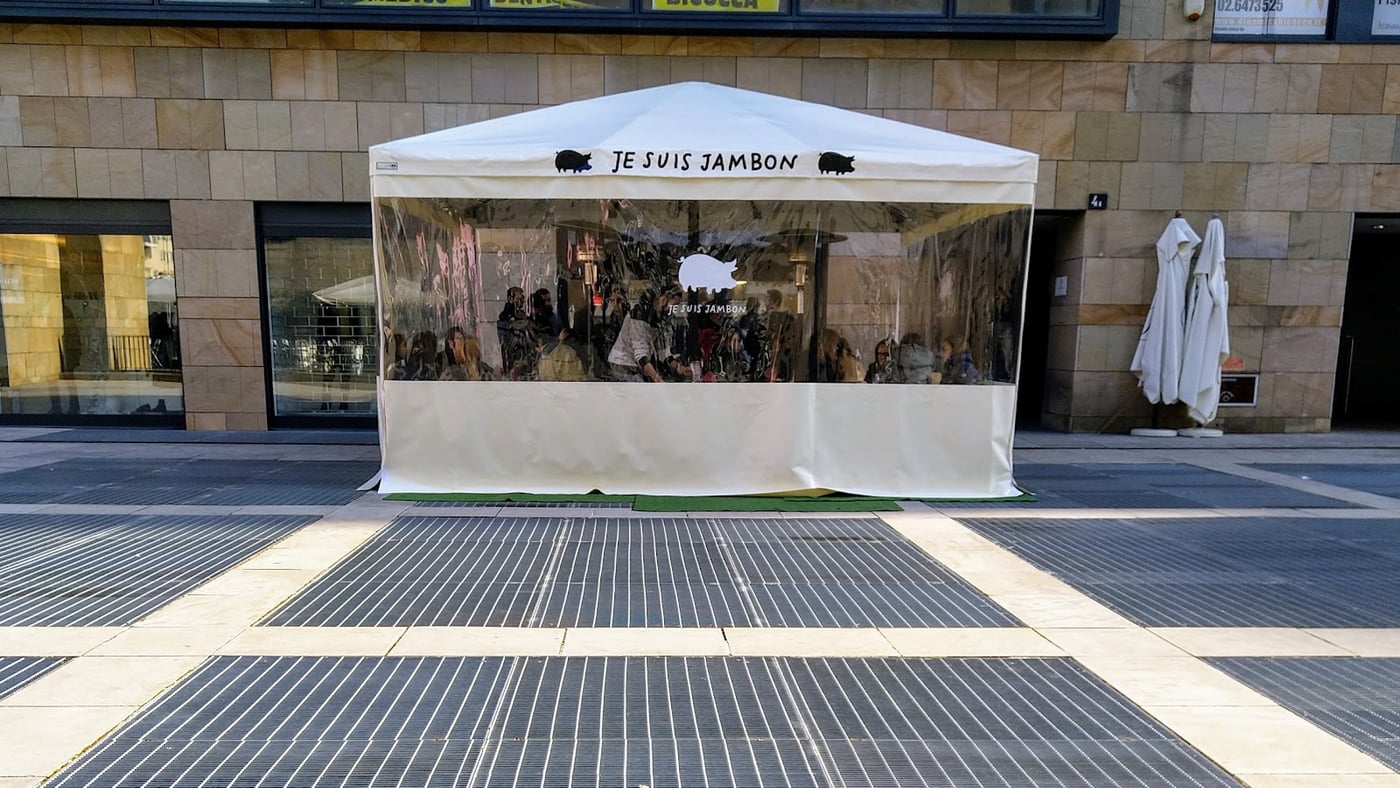 Il gazebo bianco del locale in piazza della Trivulziana, con la scritta Je Suis Jambon e due maialini sul frontone